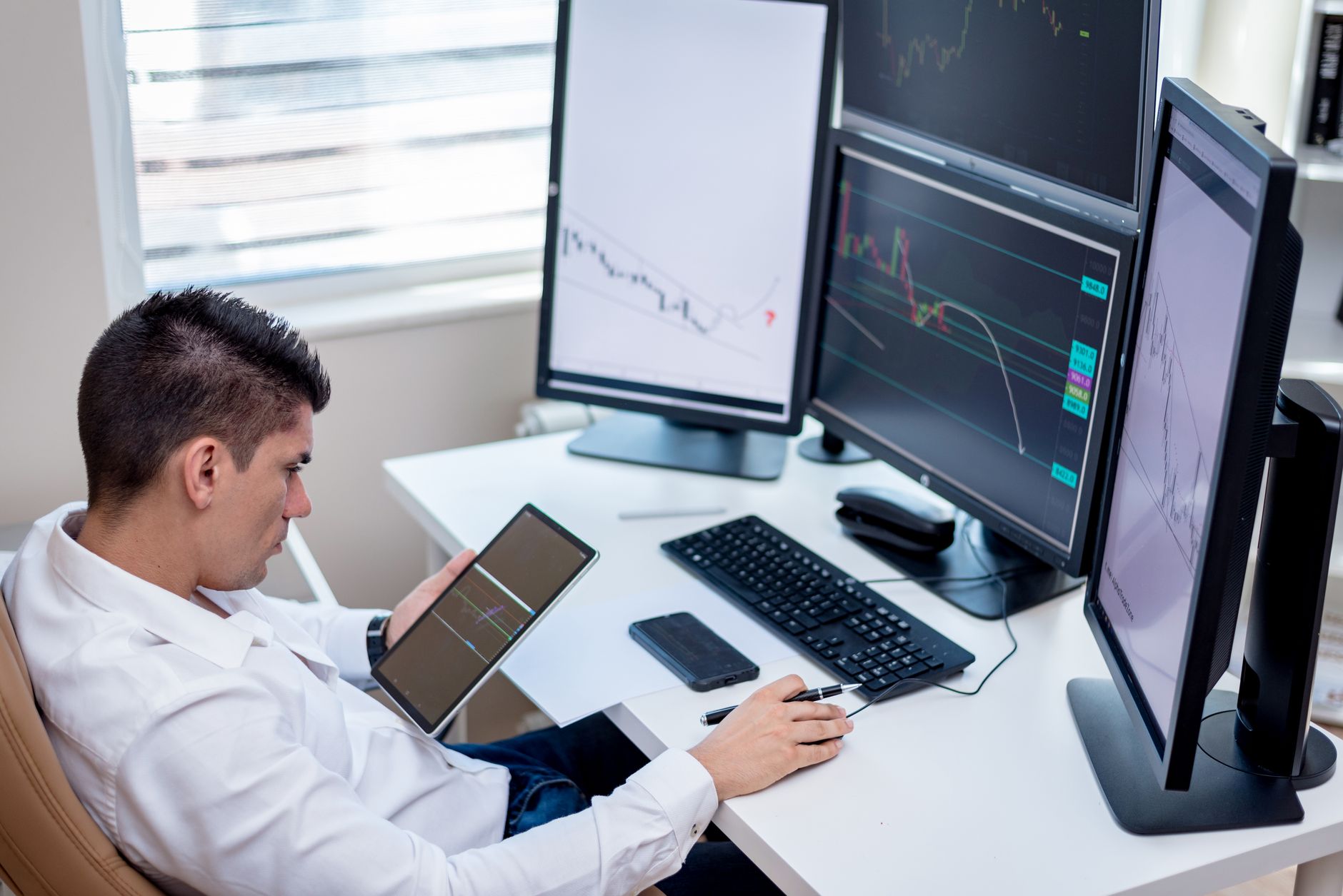 Crypto trading terminal with multiple monitors showing live charts