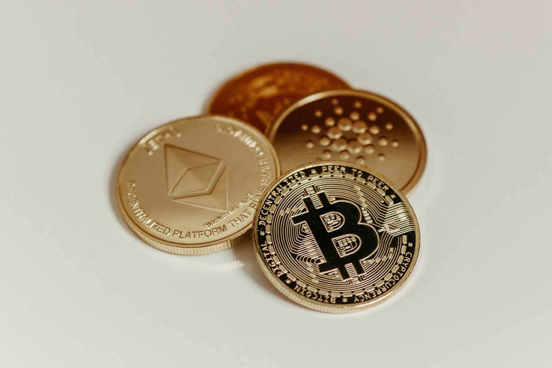 Close-up view of assorted cryptocurrency coins featuring Bitcoin, Litecoin, and others, symbolizing digital finance.