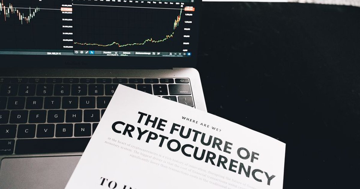 A detailed look at cryptocurrency market trends using a laptop and analytical document.