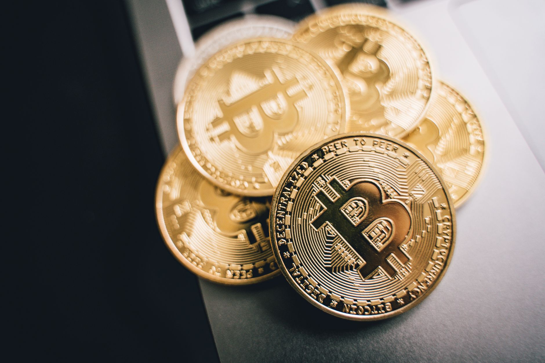 Bitcoin coins on a table representing peer-to-peer no KYC trading