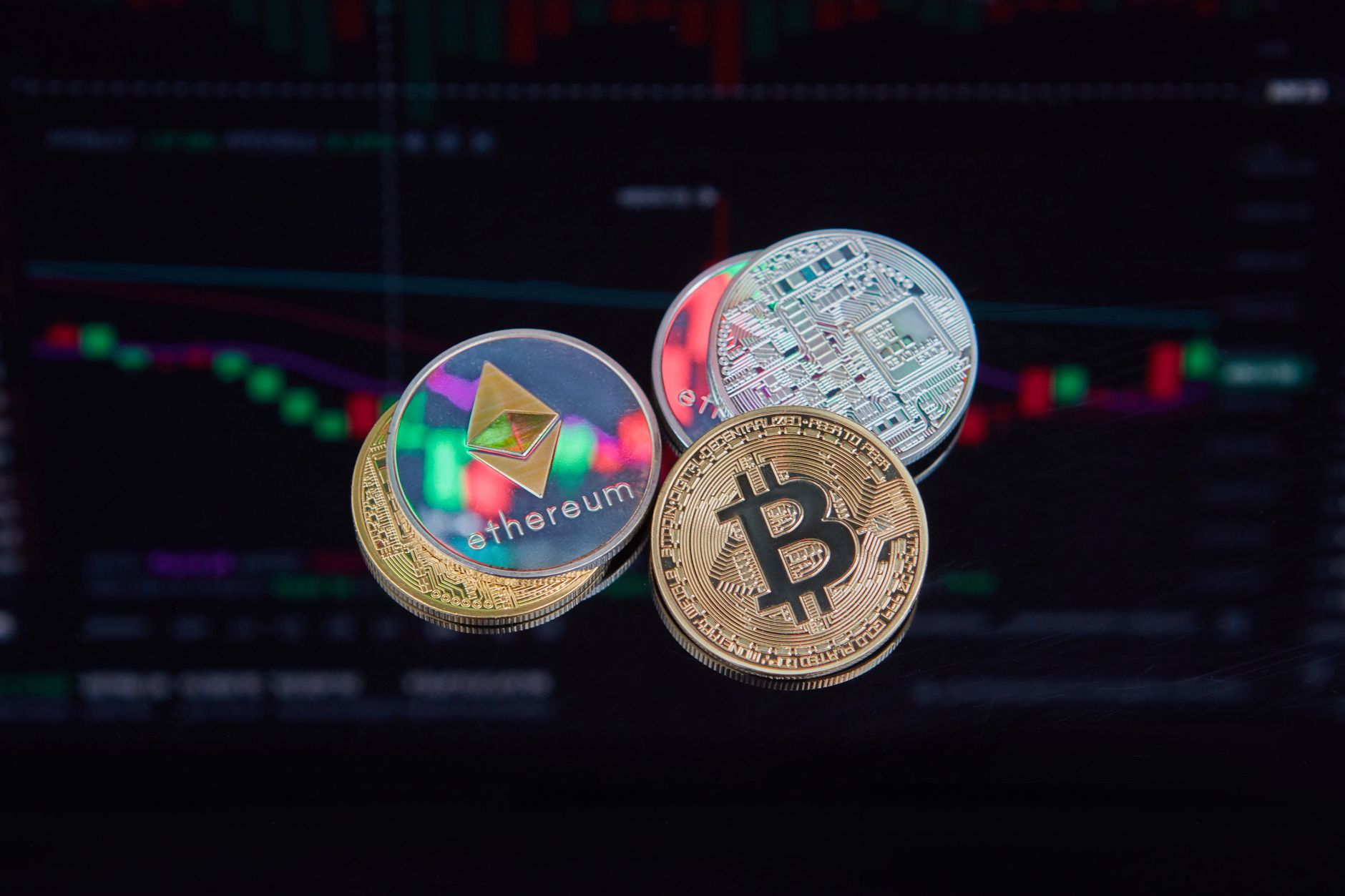 A grid of altcoin logos and price charts on a trading screen.
