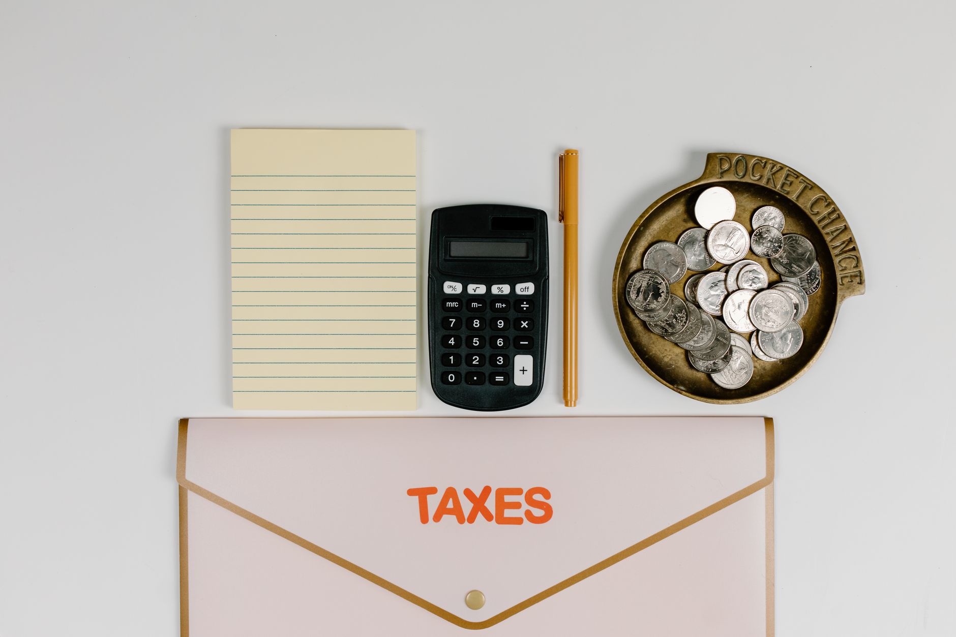 Person reviewing cryptocurrency tax documents with a calculator