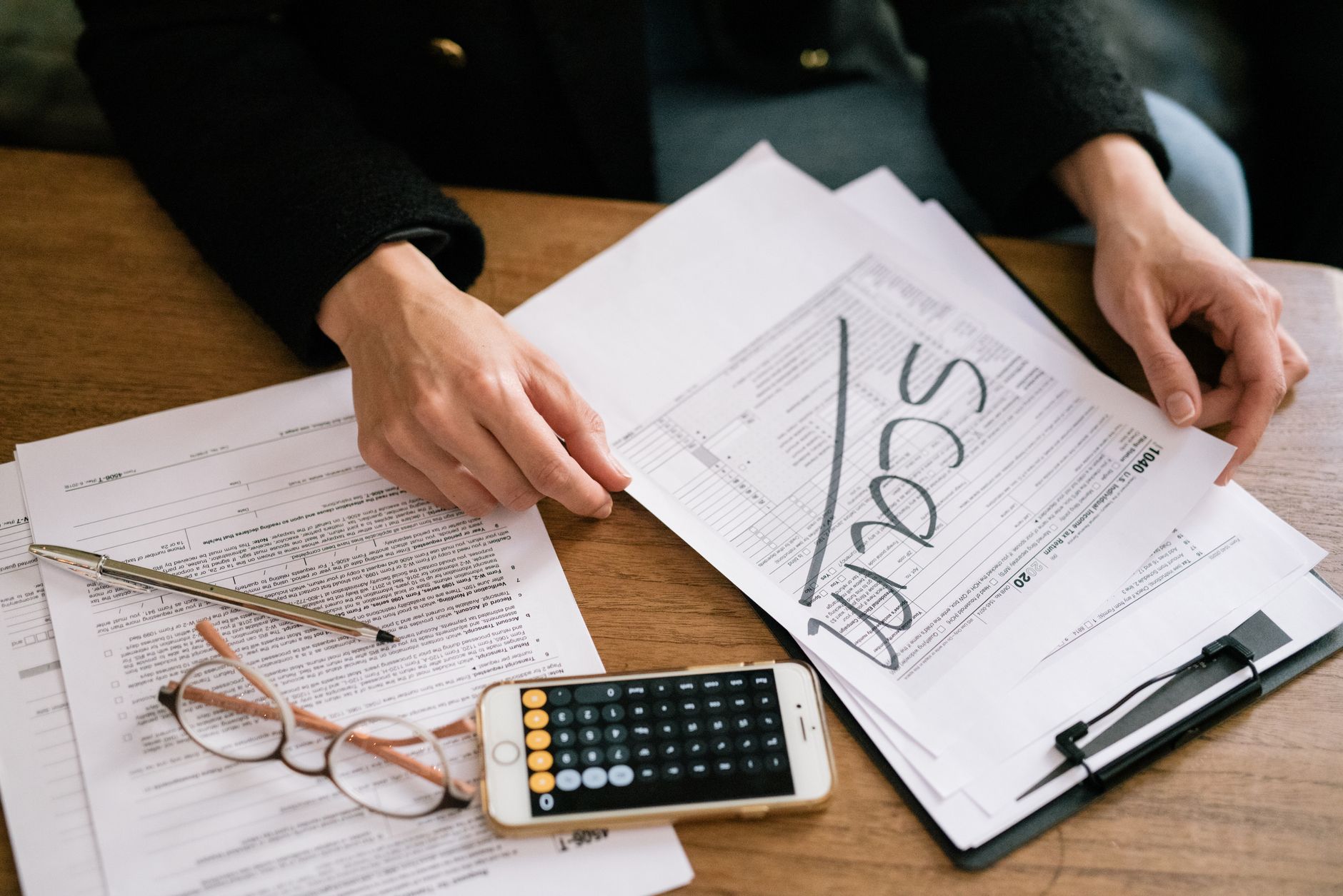 Canadian tax forms and calculator on a desk for crypto reporting
