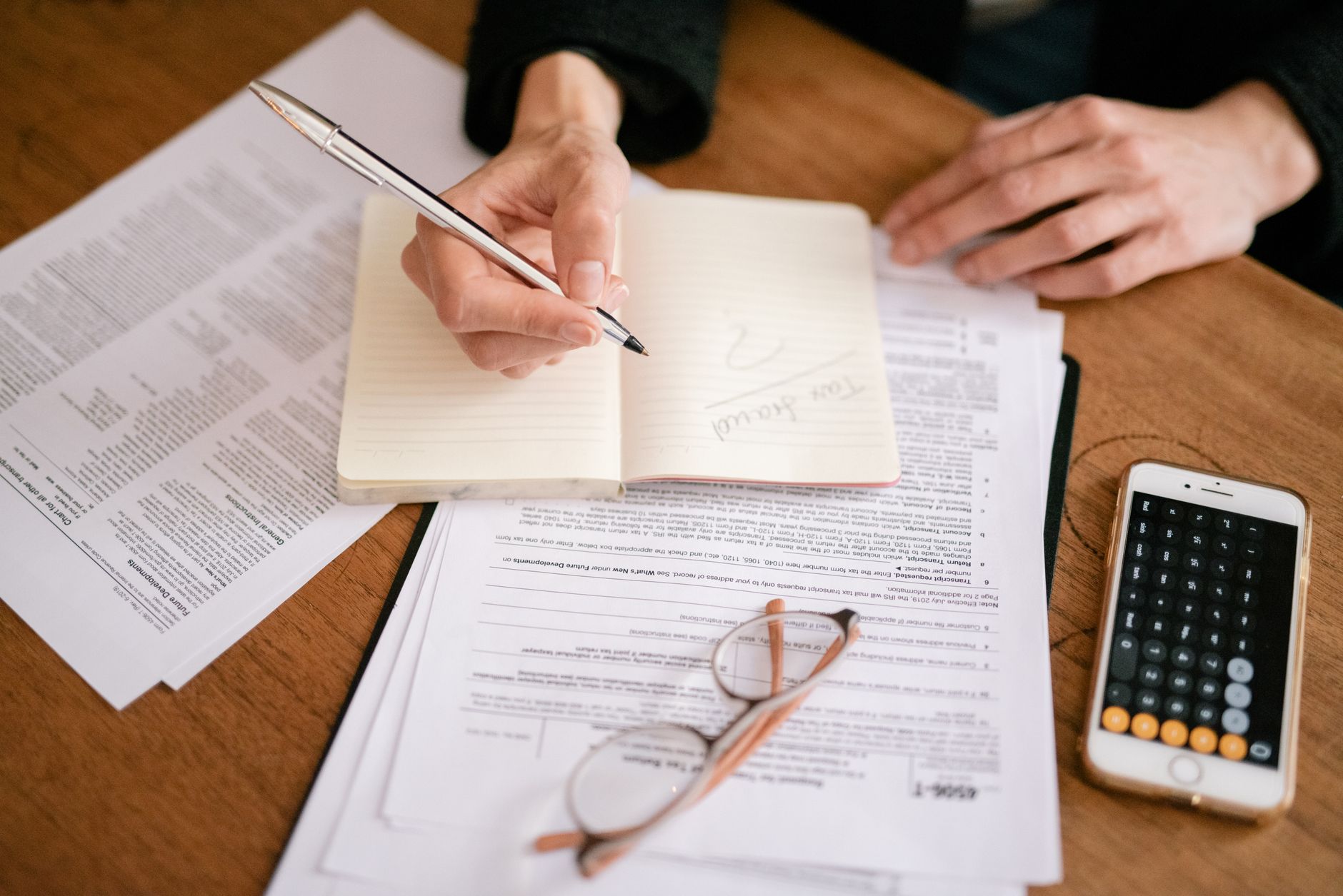 Tax forms and calculator showing capital gains brackets