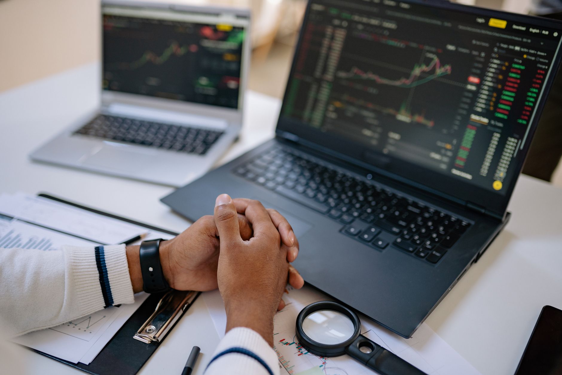 Trader monitoring multiple cryptocurrency charts on computer screens