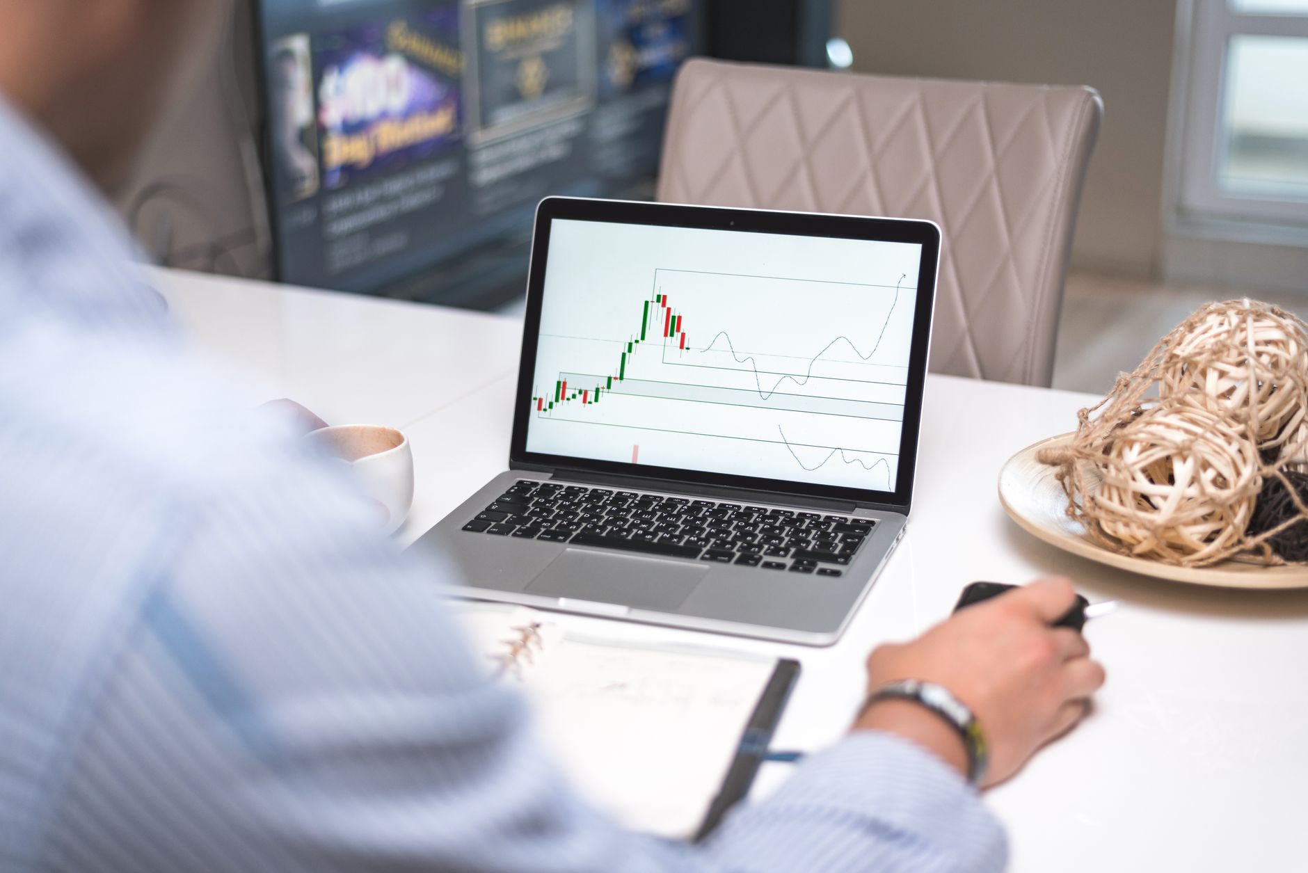 Person comparing trading strategies on a laptop with crypto charts