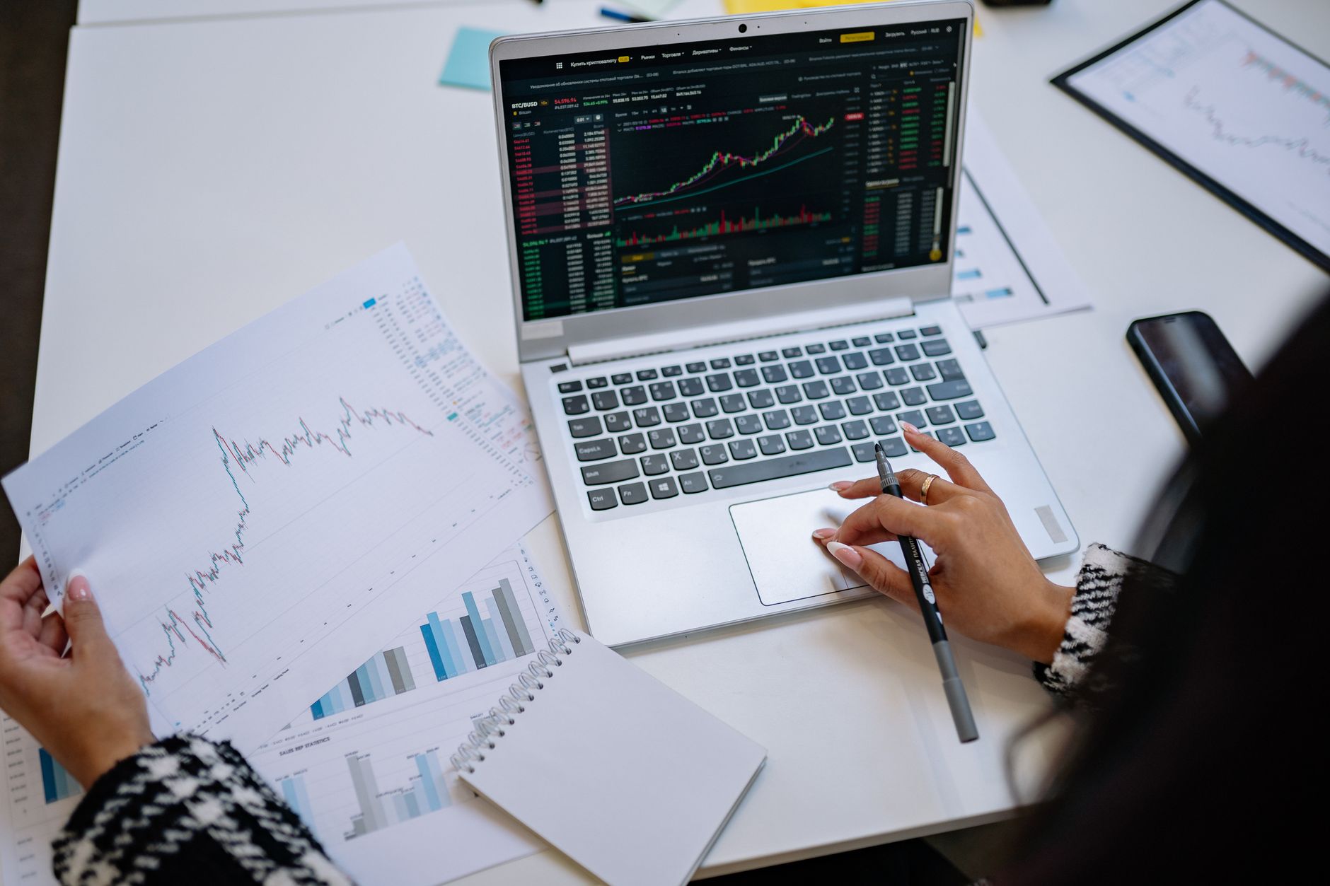 Laptop displaying cryptocurrency trading charts and buy orders
