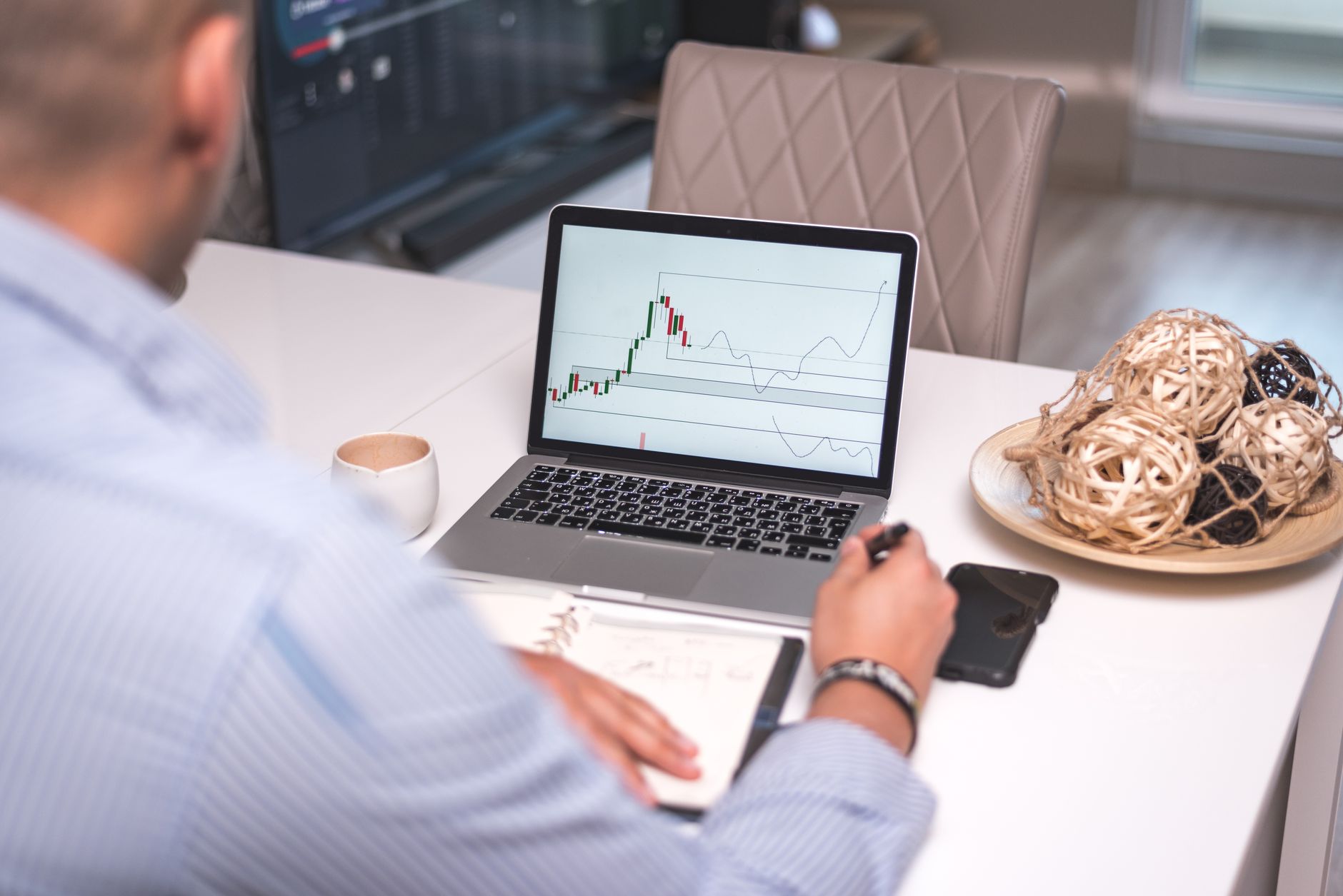 Trader researching crypto airdrops on a laptop with price charts